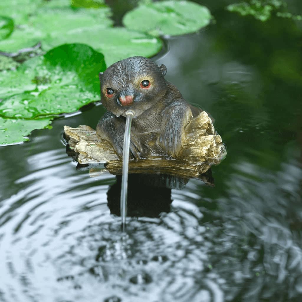 Ubbink Floating Spitter Garden Fountain Otter, Enhance your pond with the elegant, weather-resistant Ubbink Otter Garden Fountain. Features a captivating otter on a tree trunk.